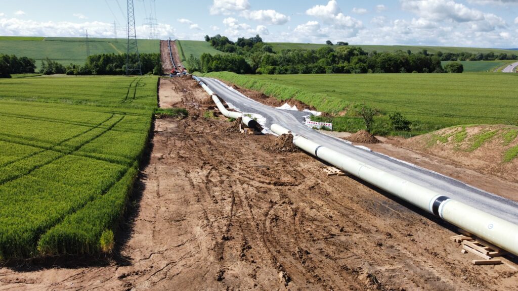 String of large diameter pipes with tough external protection in the German country side prior to open trench installation